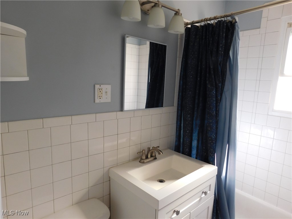 1705 Douglas Road Wickliffe, OH 44092 - Photo 8 of 27 Bathroom with shower / bath combo, vanity, and tile walls