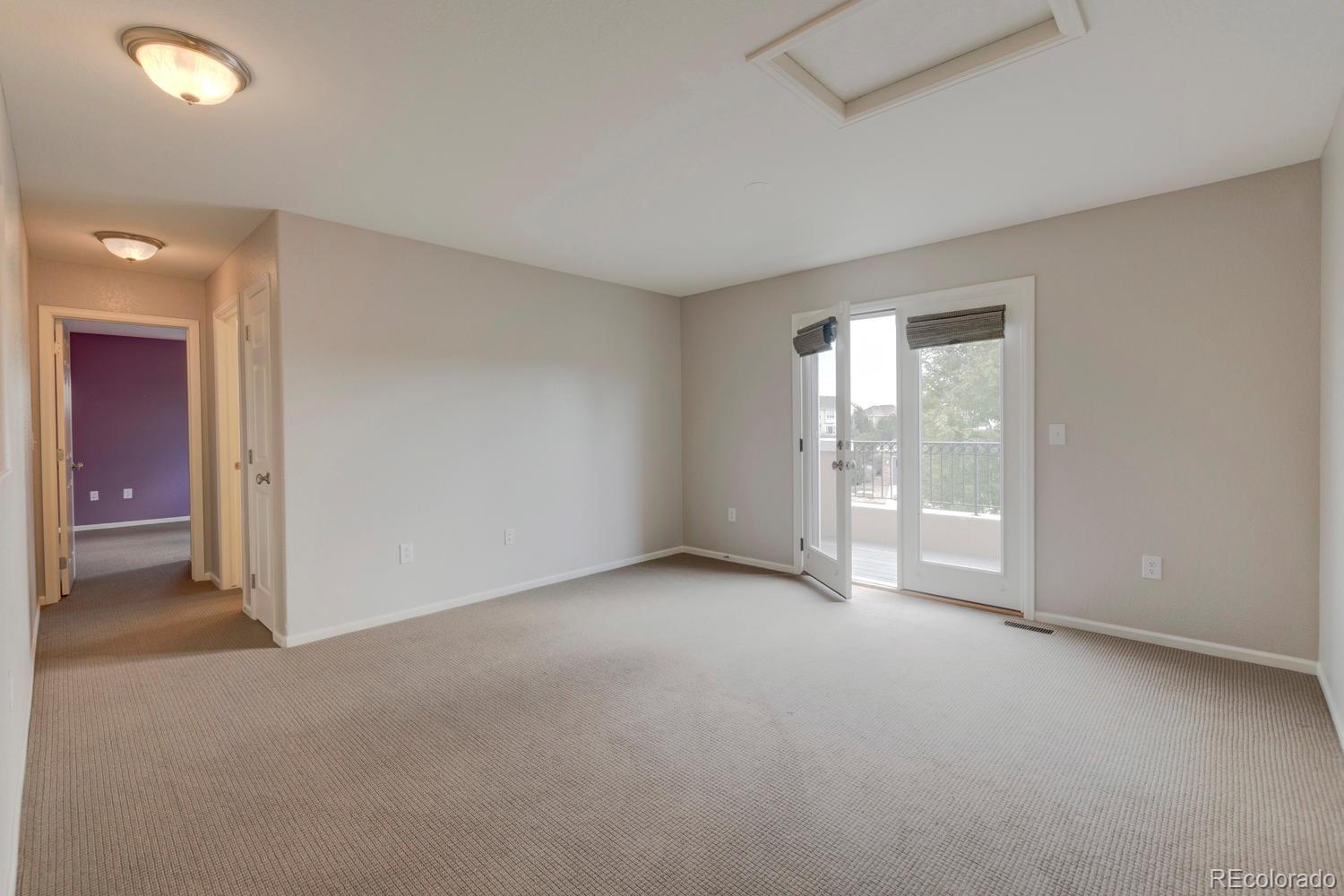 4939 Silver Feather Circle Broomfield, CO 80023 - Photo 17 of 35 an empty room with windows and entrance