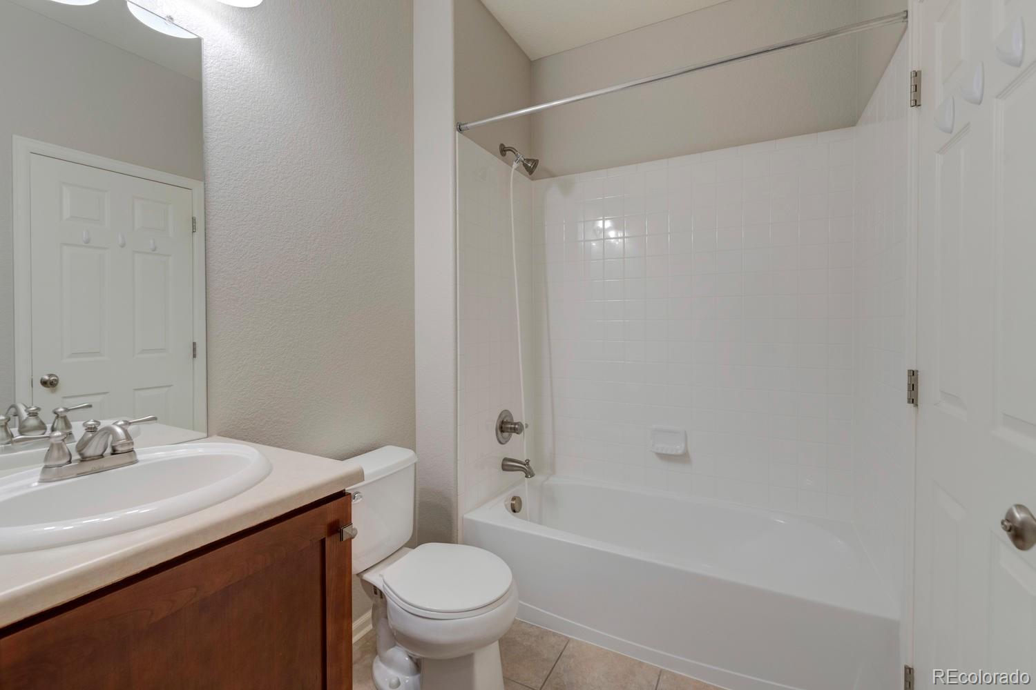 4939 Silver Feather Circle Broomfield, CO 80023 - Photo 26 of 35 a bathroom with a sink toilet and shower