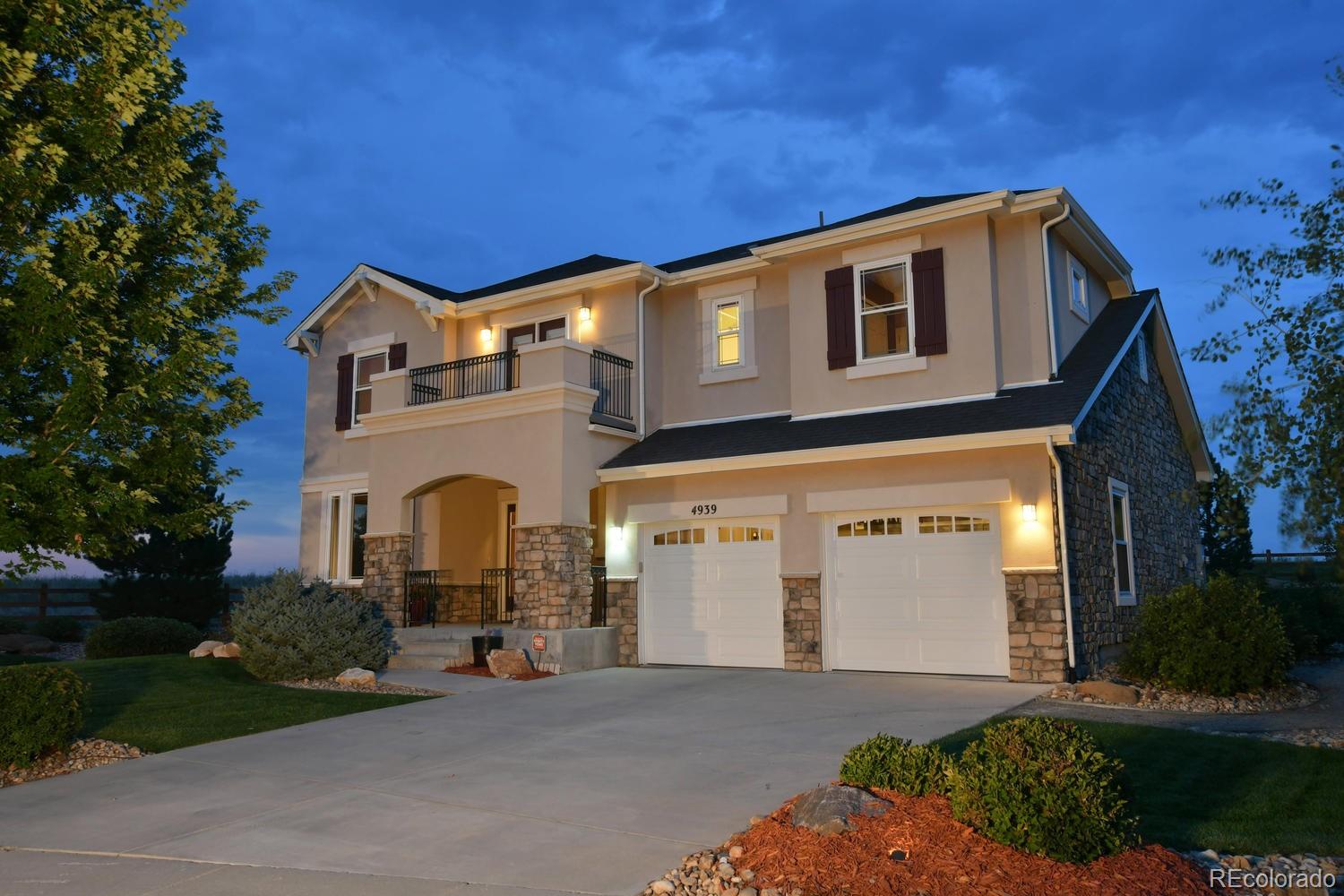 4939 Silver Feather Circle Broomfield, CO 80023 - Photo 3 of 35 a front view of a house with a yard