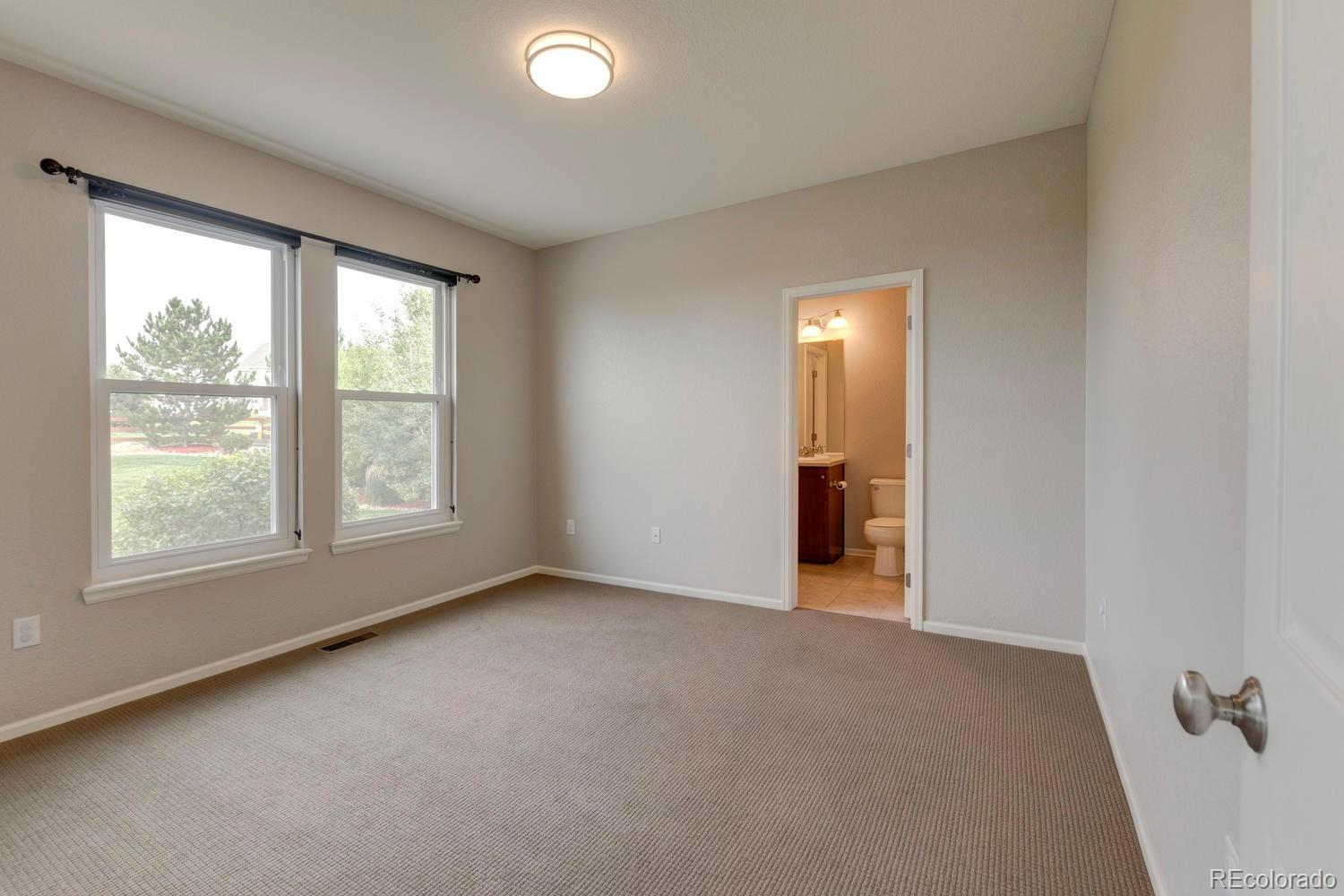 4939 Silver Feather Circle Broomfield, CO 80023 - Photo 9 of 35 an empty room with a window and a ceiling fan