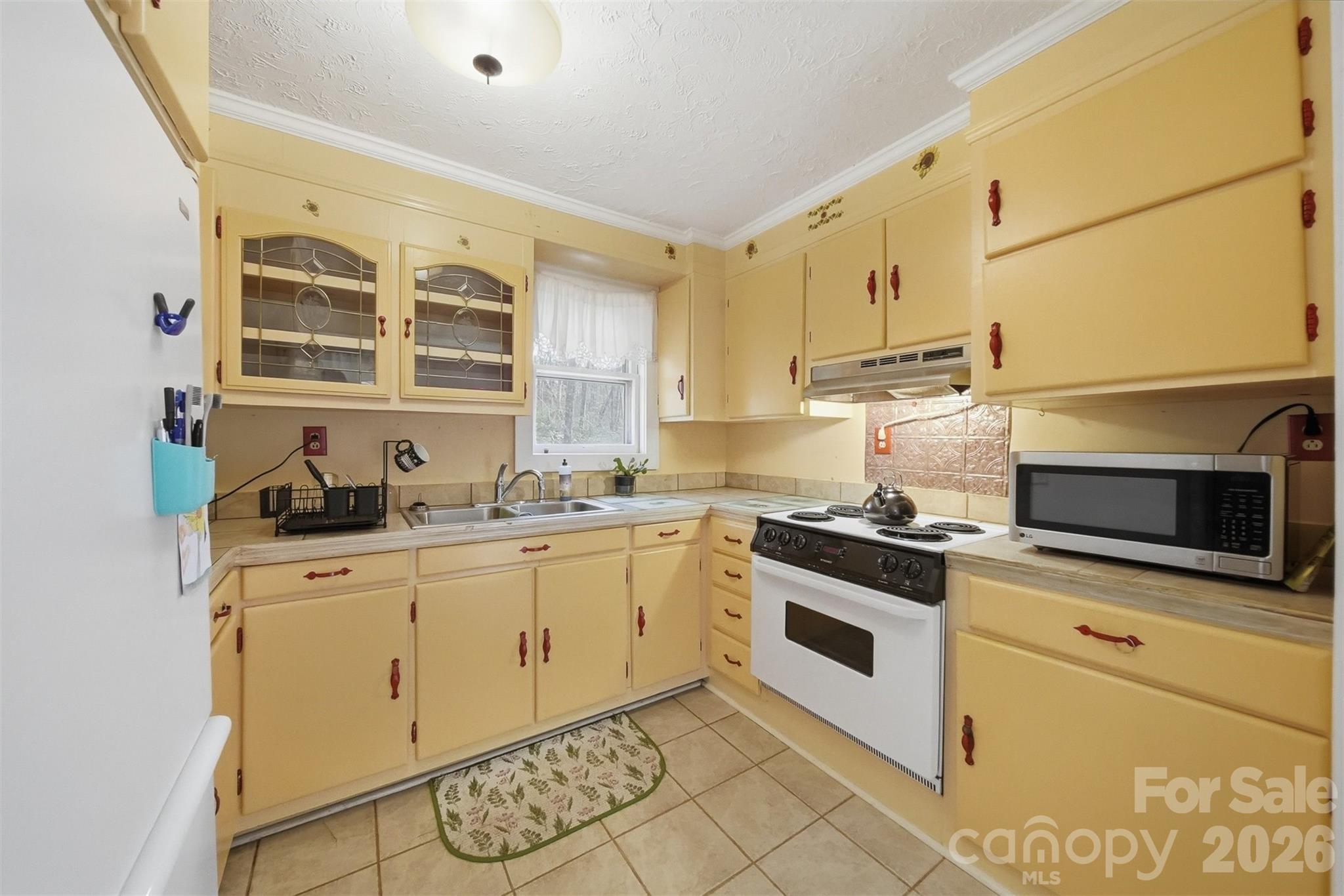 621 Wildlife Lake Road Old Fort, NC 28762 - Photo 12 of 35 a kitchen with stainless steel appliances granite countertop a stove and a sink