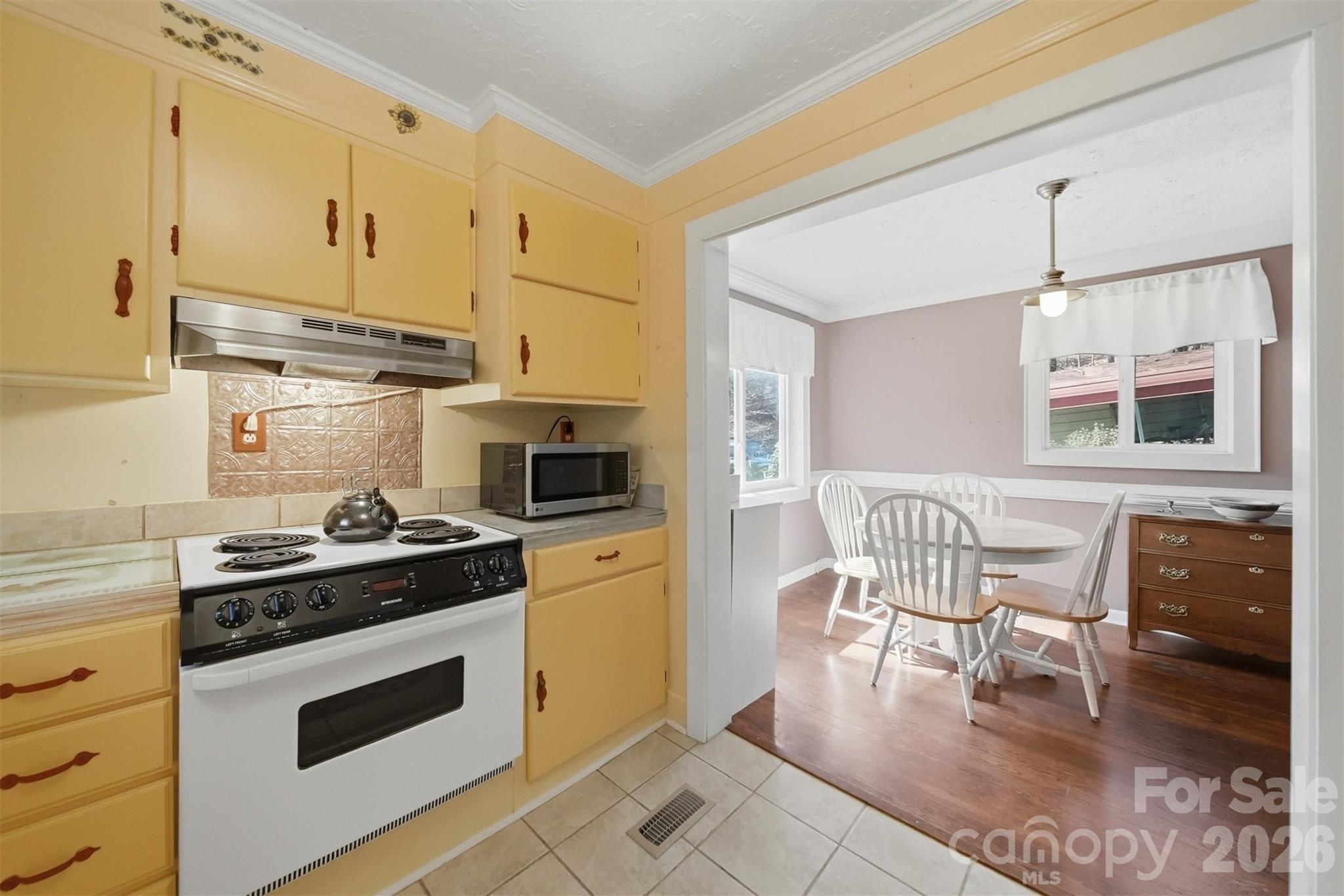 621 Wildlife Lake Road Old Fort, NC 28762 - Photo 13 of 35 a kitchen with a stove a sink and chairs