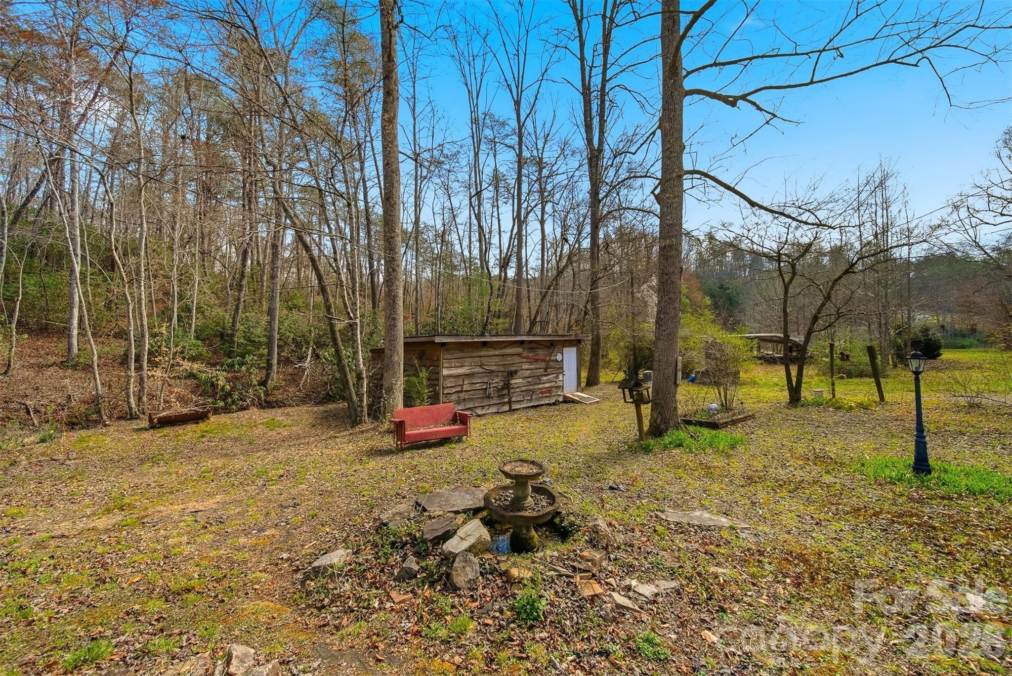 621 Wildlife Lake Road Old Fort, NC 28762 - Photo 23 of 35 a backyard of a house with table and chairs