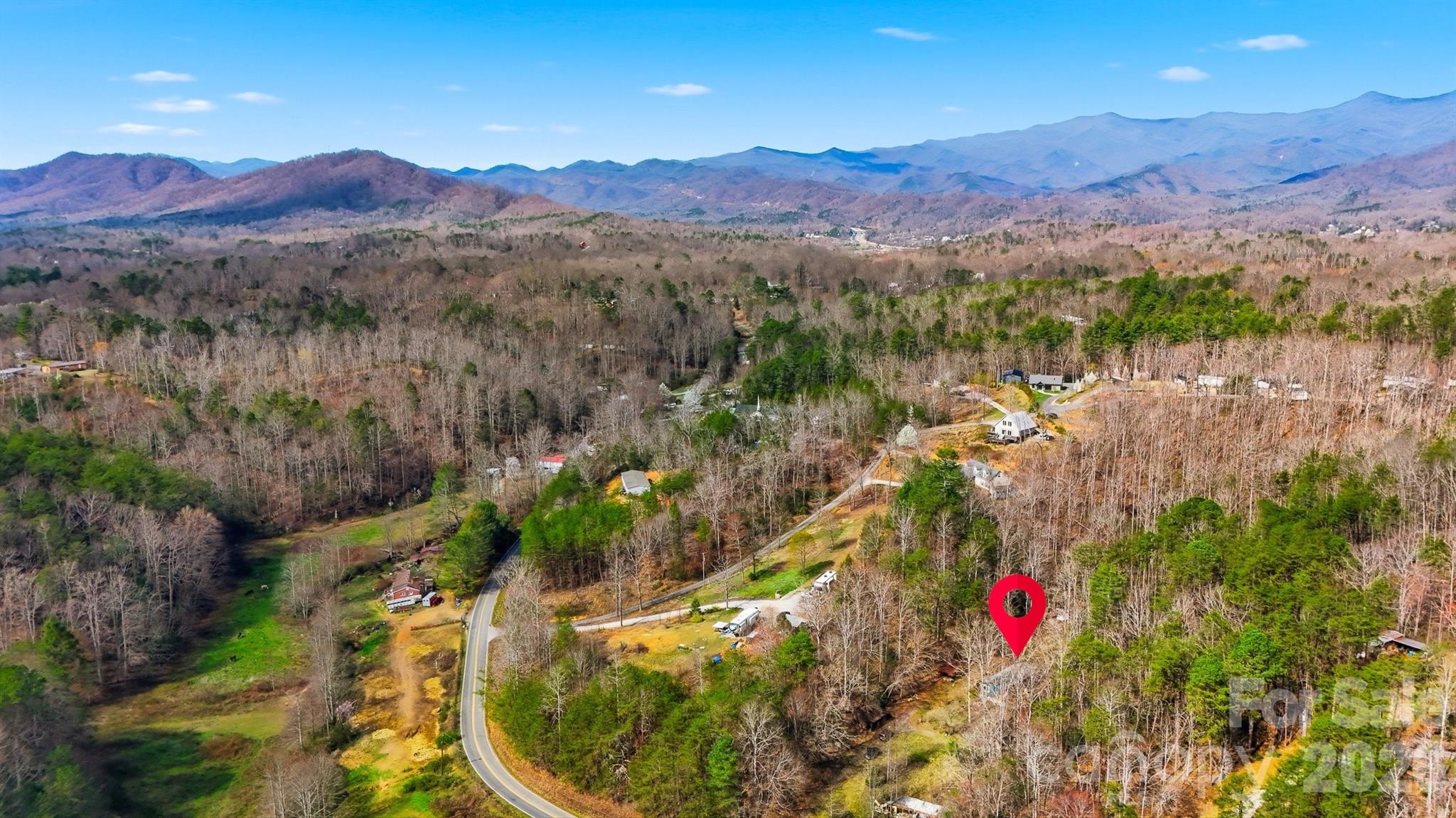 621 Wildlife Lake Road Old Fort, NC 28762 - Photo 30 of 35 a view of a lush green hillside and a houses