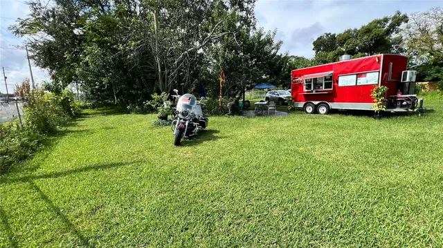 a car parked in front of a house with a yard