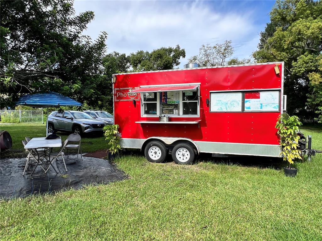 730 North Combee Road Lakeland, FL 33801 - Photo 5 of 5 a car parked in front of a house with a yard