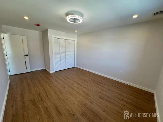 a bathroom with a granite countertop sink toilet and mirror