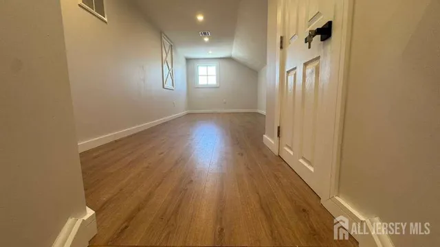 a view of hallway with wooden floor
