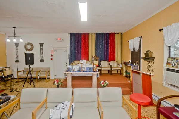a living room filled with furniture and a large window