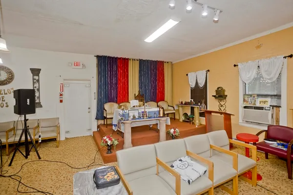 a living room with fireplace furniture and a large window