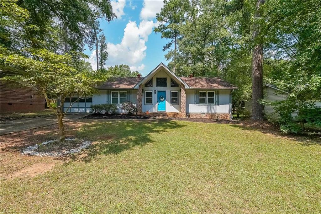 820 Bridgewater Way Southeast Conyers, GA 30094 - Photo 1 of 19 a front view of a house with a yard table and chairs