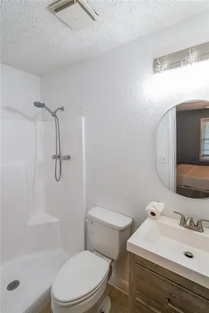 a bathroom with a sink toilet and shower