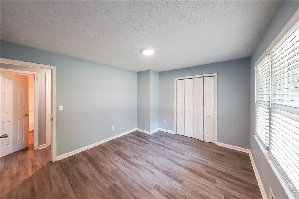 820 Bridgewater Way Southeast Conyers, GA 30094 - Photo 14 of 19 an empty room with wooden floor and windows