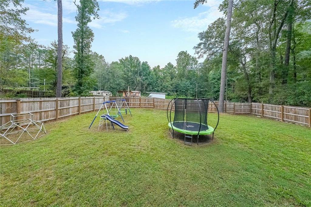 820 Bridgewater Way Southeast Conyers, GA 30094 - Photo 18 of 19 a view of a backyard with swimming pool