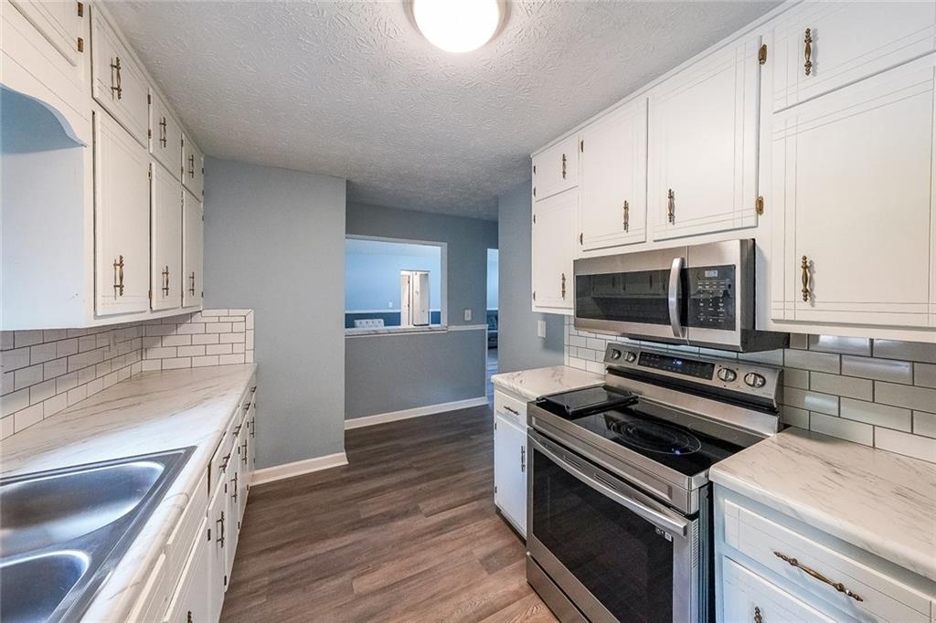 820 Bridgewater Way Southeast Conyers, GA 30094 - Photo 7 of 19 a kitchen with a stove and a microwave