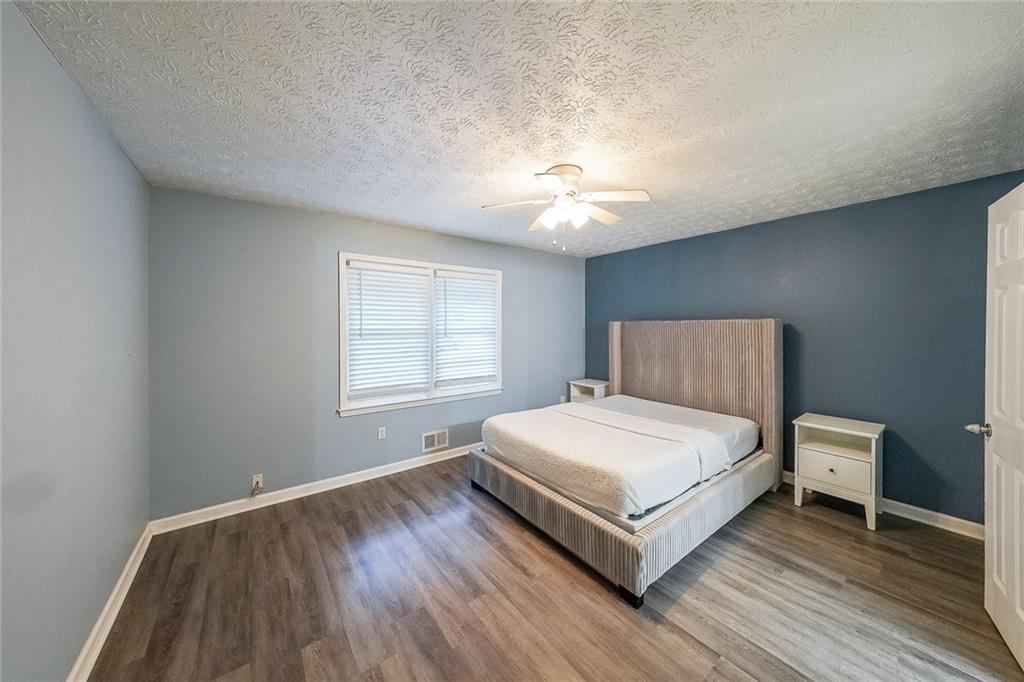 820 Bridgewater Way Southeast Conyers, GA 30094 - Photo 9 of 19 a bedroom with a bed and a night stand