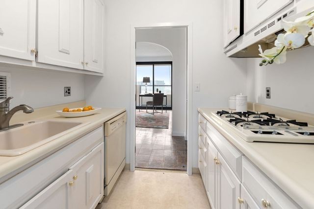 a kitchen with stainless steel appliances granite countertop a sink and cabinets