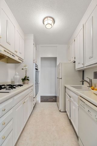 a kitchen with stainless steel appliances granite countertop a sink and cabinets