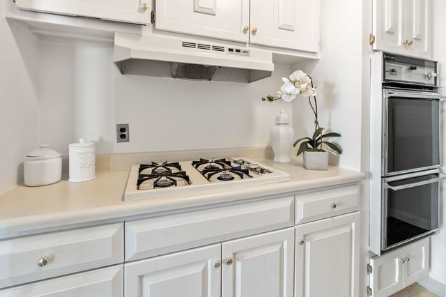 a kitchen with a stove and a refrigerator