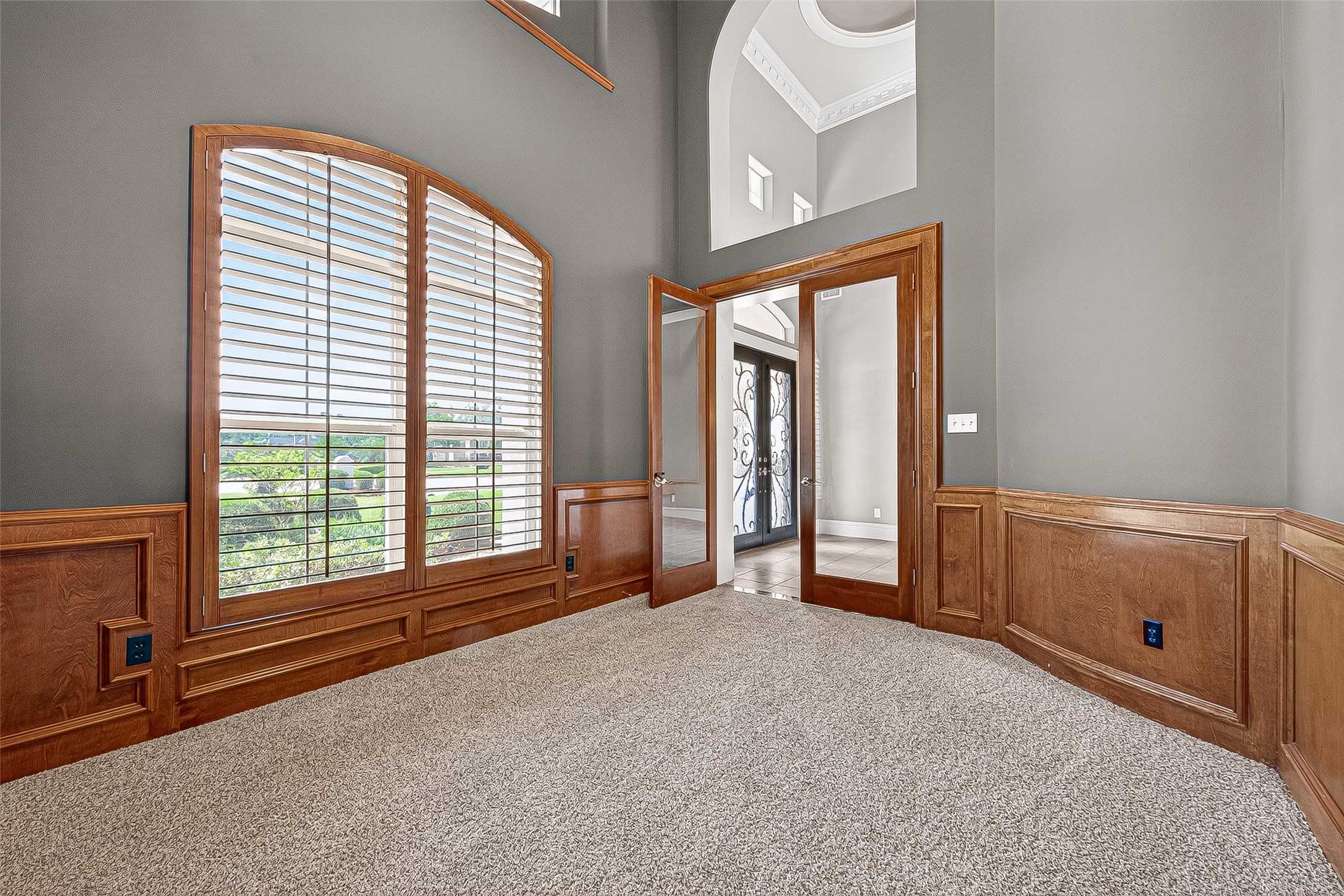 25626 Windy Isle Court Spring, TX 77389 - Photo 8 of 45 Directly right of the entrance is the study with high ceilings, elegant wood paneling, built in desk area and large book shelves. A wonderful space to study, work or hobbies.