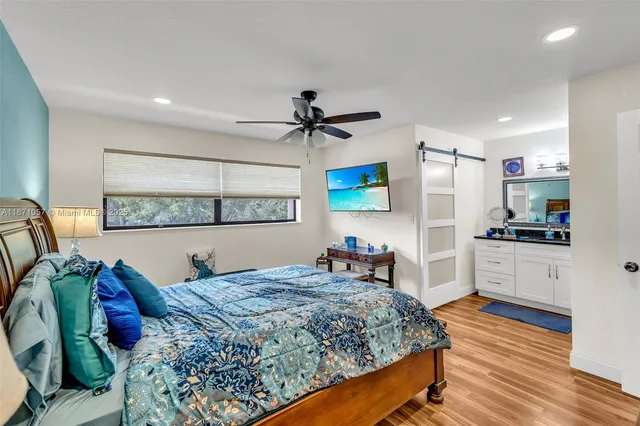 a bed room with a bed and a television