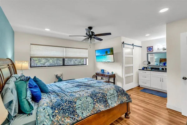 a bed room with a bed and a television