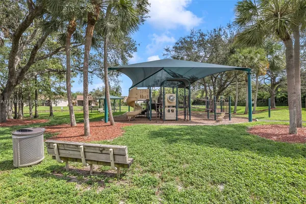 a view of a yard with a slide and table