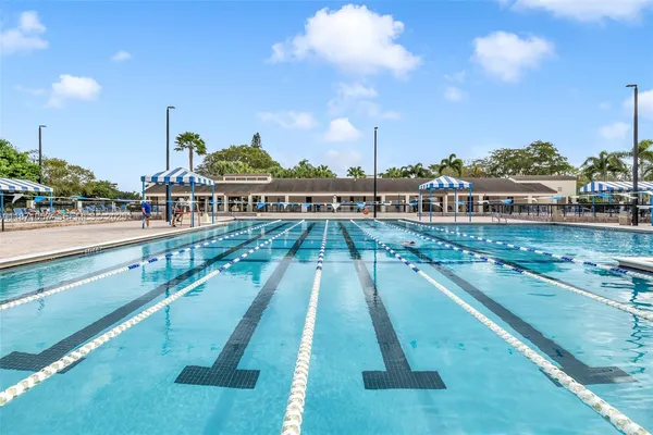 a view of swimming pool with outdoor seating and city view