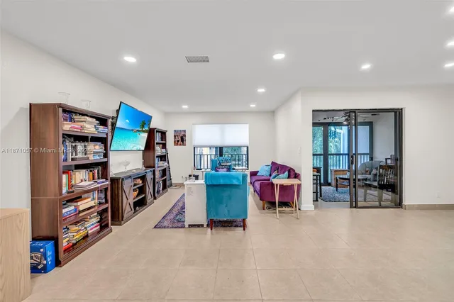 a living room with furniture and a book shelf