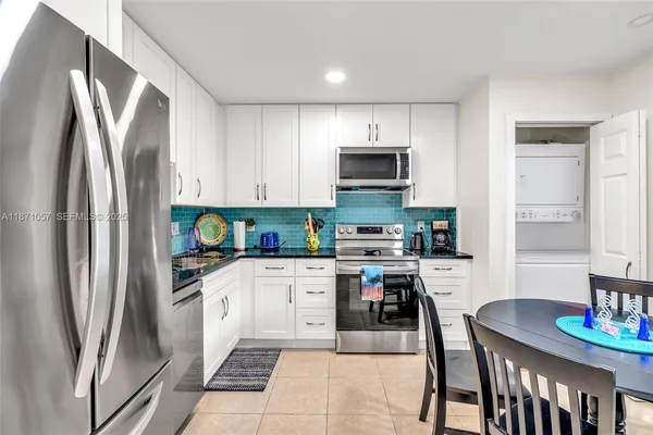 a kitchen with stainless steel appliances a refrigerator sink and microwave