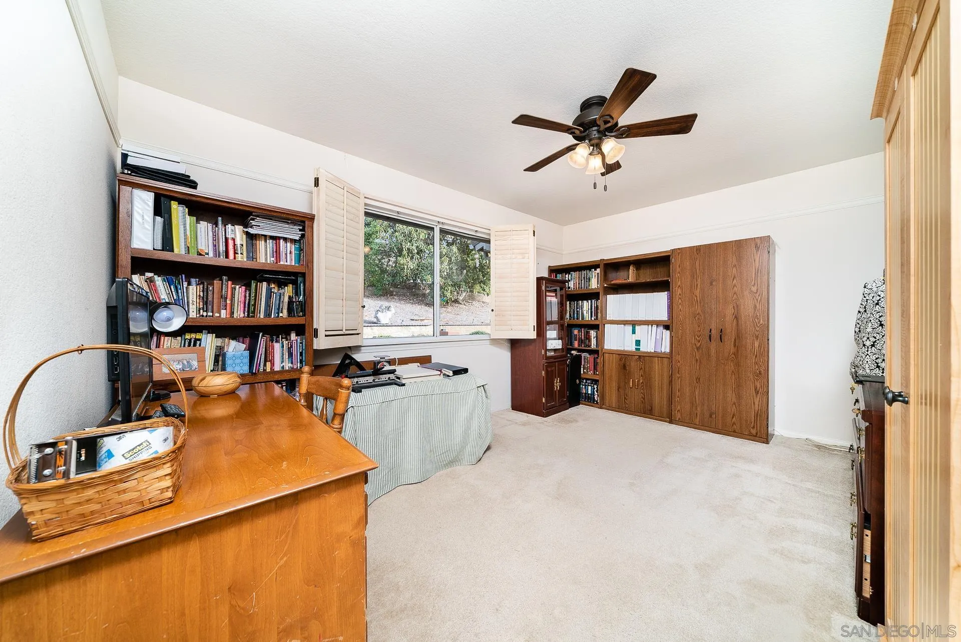 3909 Palomar Drive Fallbrook, CA 92028 - Photo 20 of 43 a bed room with a bed and a book shelf