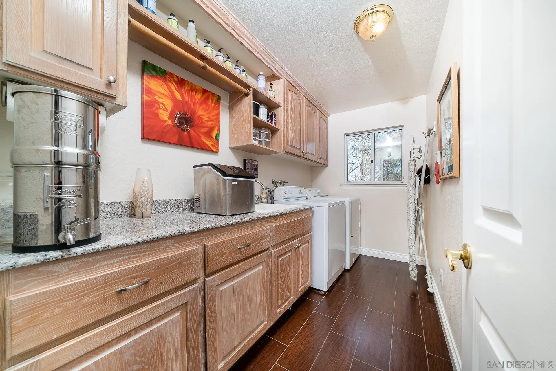 3909 Palomar Drive Fallbrook, CA 92028 - Photo 24 of 43 a kitchen with stainless steel appliances a sink and wooden floor