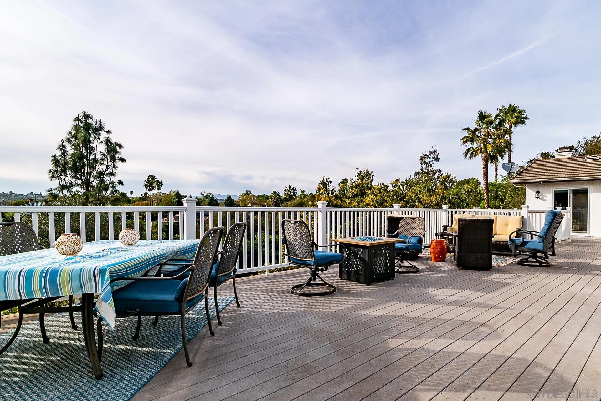 3909 Palomar Drive Fallbrook, CA 92028 - Photo 25 of 43 a view of a roof deck with table and chairs couches and wooden floor