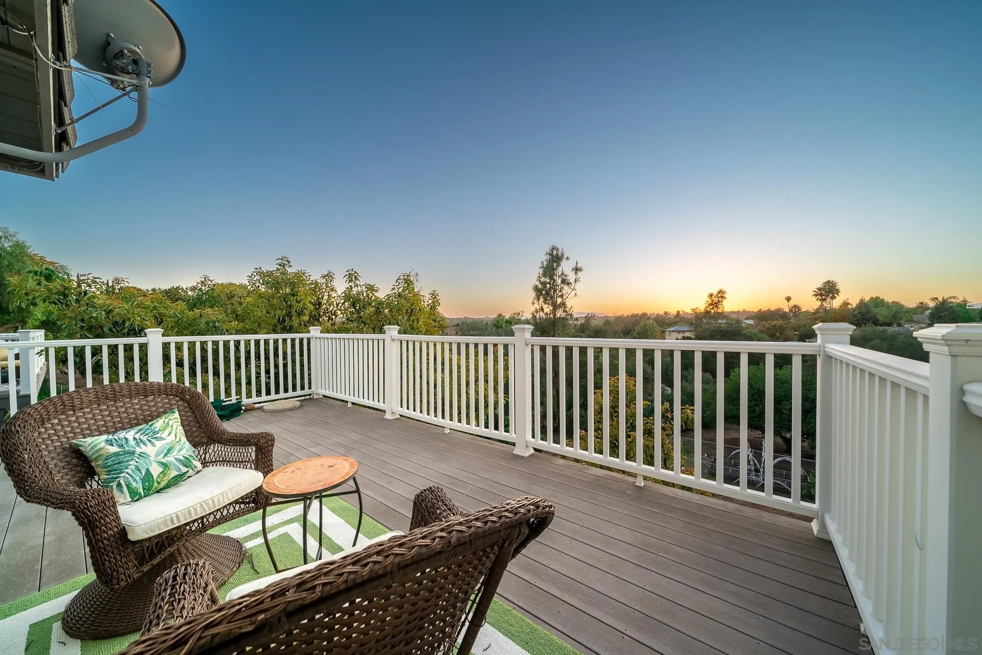 3909 Palomar Drive Fallbrook, CA 92028 - Photo 28 of 43 a balcony with wooden floor table and chairs