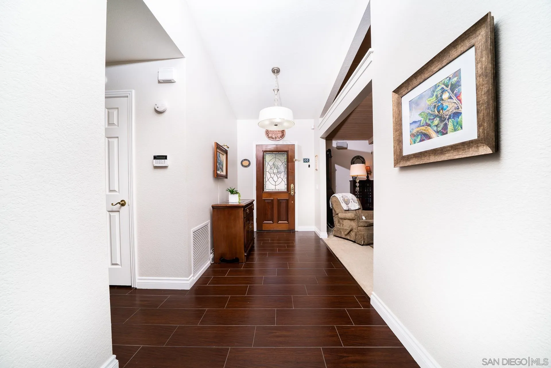 3909 Palomar Drive Fallbrook, CA 92028 - Photo 5 of 43 a hallway with painting on wall and a large mirror