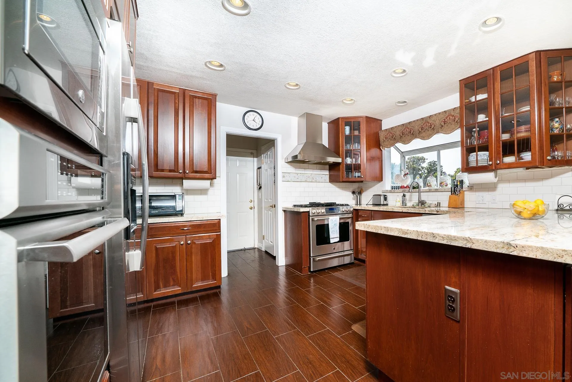 3909 Palomar Drive Fallbrook, CA 92028 - Photo 8 of 43 a kitchen with stainless steel appliances granite countertop a sink stove and refrigerator