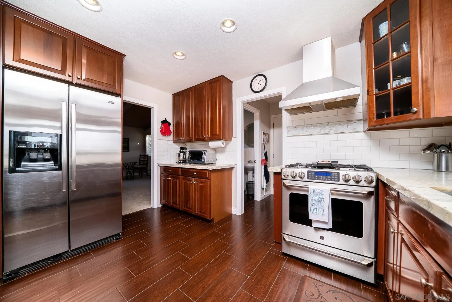 3909 Palomar Drive Fallbrook, CA 92028 - Photo 9 of 43 a kitchen with stainless steel appliances a stove a refrigerator and a sink