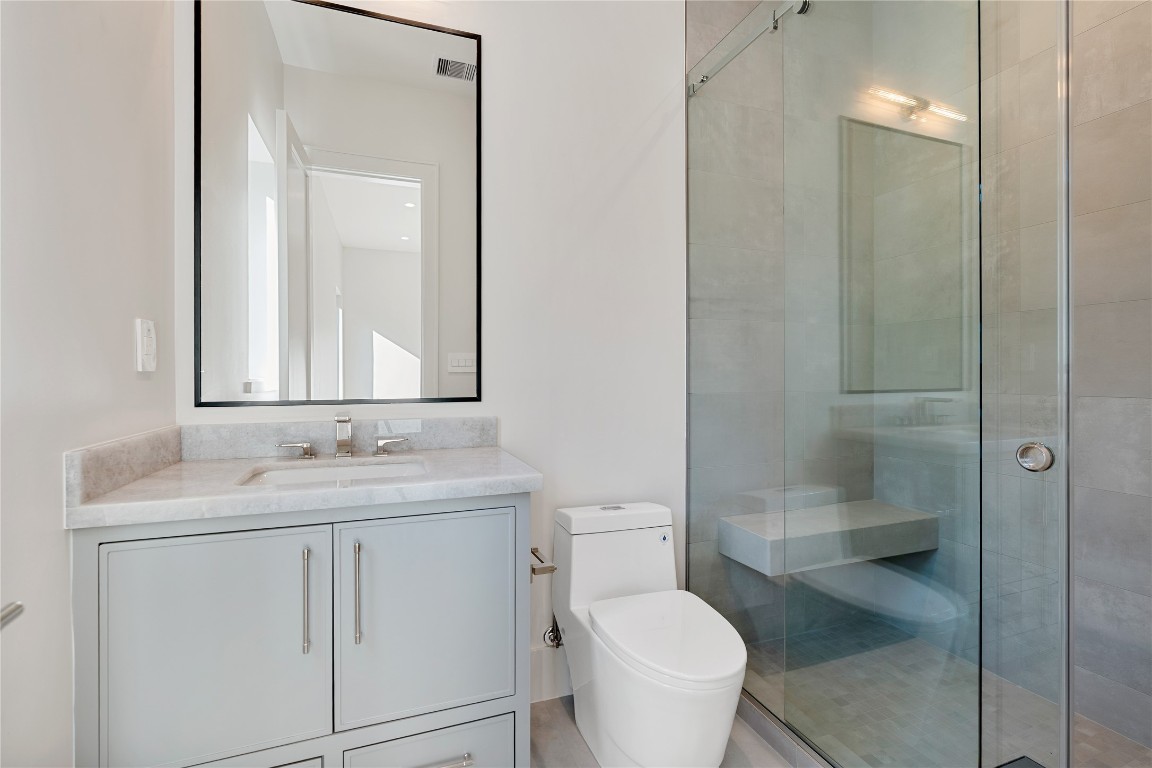 3802 Westerman Street Houston, TX 77005 - Photo 14 of 18 a bathroom with a granite countertop sink toilet and shower