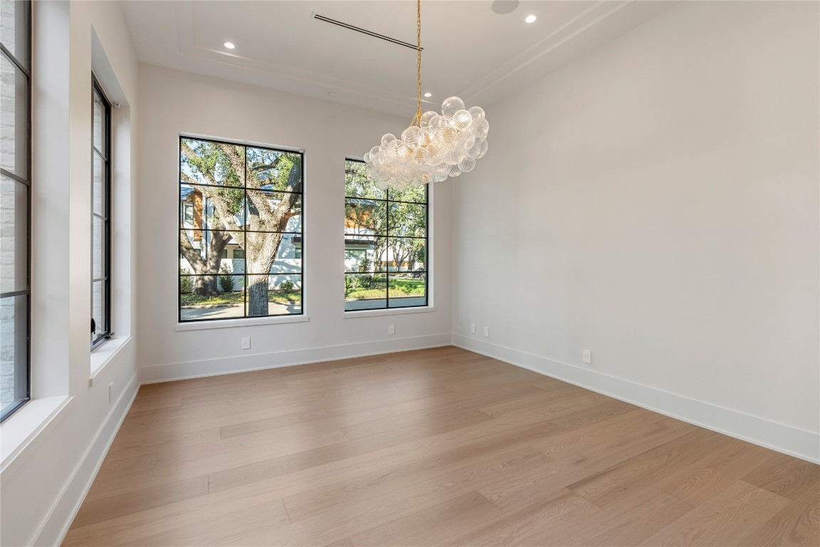 3802 Westerman Street Houston, TX 77005 - Photo 5 of 18 an empty room with windows and chandelier