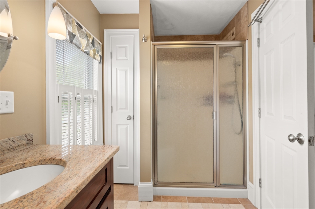 7 Charles Street Danvers, MA 01923 - Photo 16 of 37 a bathroom with a granite countertop sink and shower