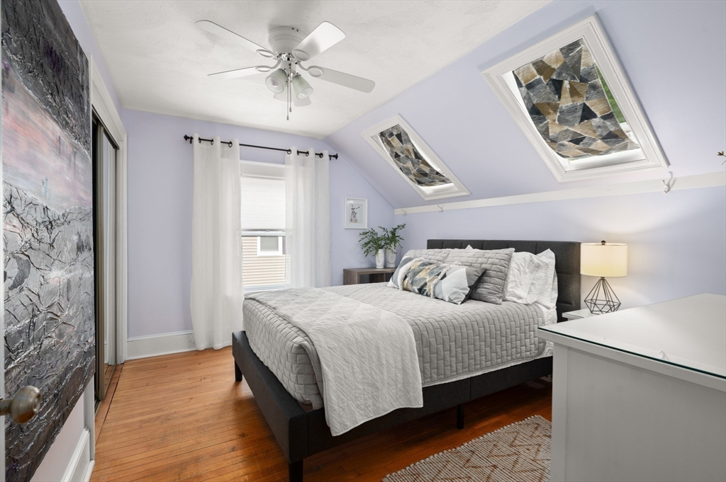 7 Charles Street Danvers, MA 01923 - Photo 17 of 37 a bedroom with a large bed and a chandelier