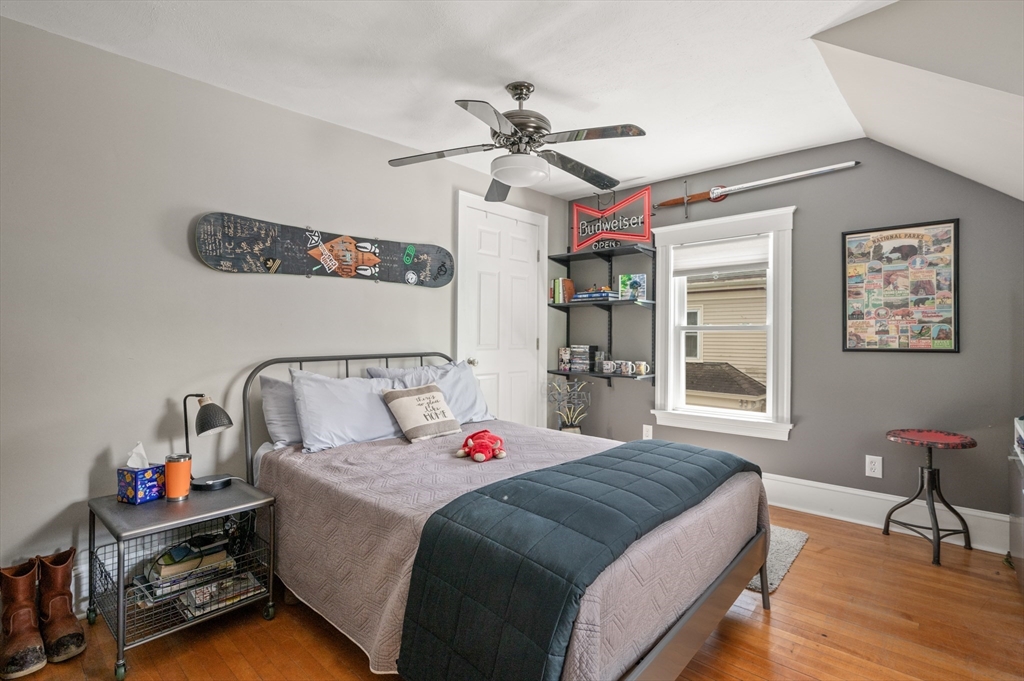 7 Charles Street Danvers, MA 01923 - Photo 23 of 37 a spacious bedroom with a bed a dresser and wooden floor