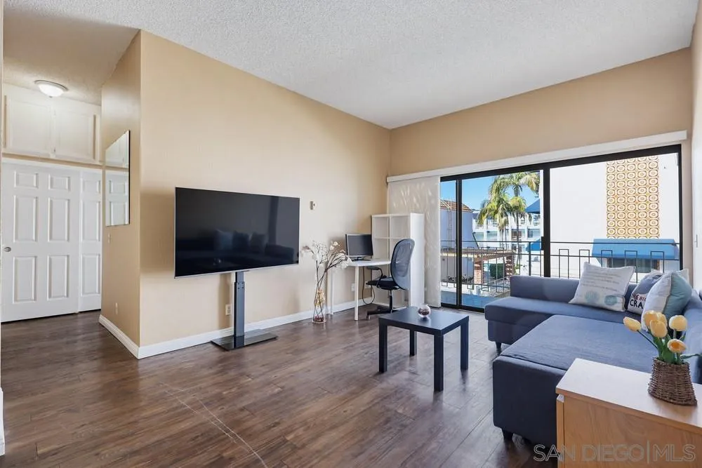 8324 Regents Road, Unit 2E San Diego, CA 92122 - Photo 13 of 31 a living room with furniture and a flat screen tv