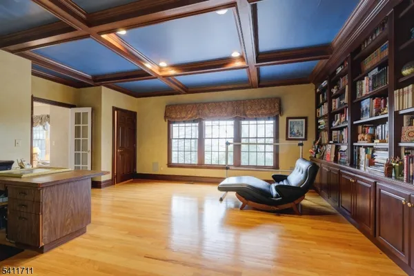 a living room with furniture fireplace and a large window