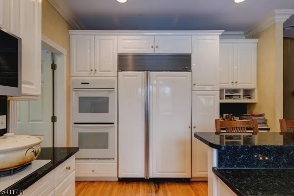a kitchen with stainless steel appliances a refrigerator and a stove top oven