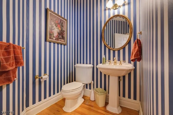 a bathroom with a sink a mirror and a toilet