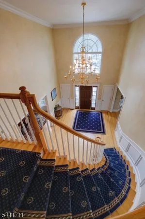 a view of a living room a rug and chandelier