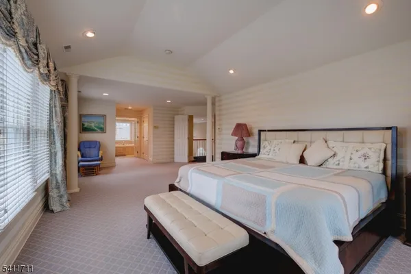 a view of a hallway with a livingroom and a bathroom