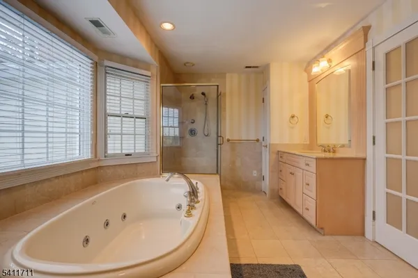 a bathroom with a bathtub and a shower